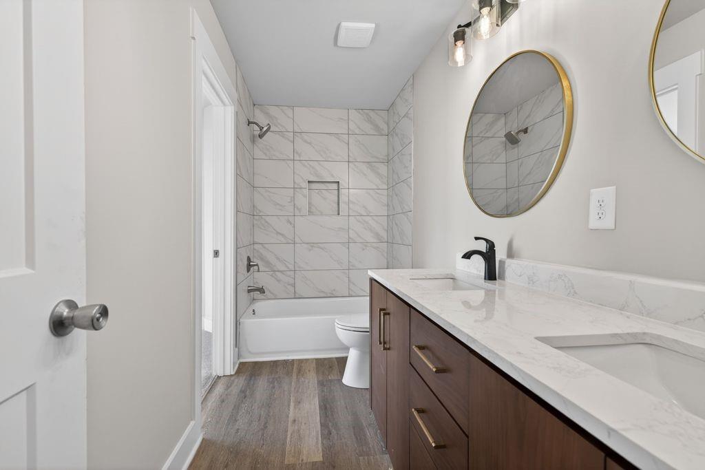 4947 Old Orr Road Flowery Branch, GA 30542 - Photo 31 of 60 a bathroom with a granite countertop sink a toilet and shower