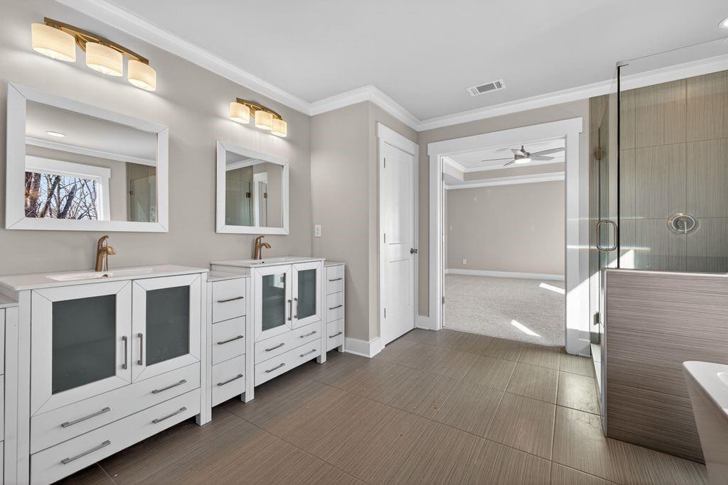 4947 Old Orr Road Flowery Branch, GA 30542 - Photo 45 of 60 a bathroom with a double vanity sink a mirror and a shower