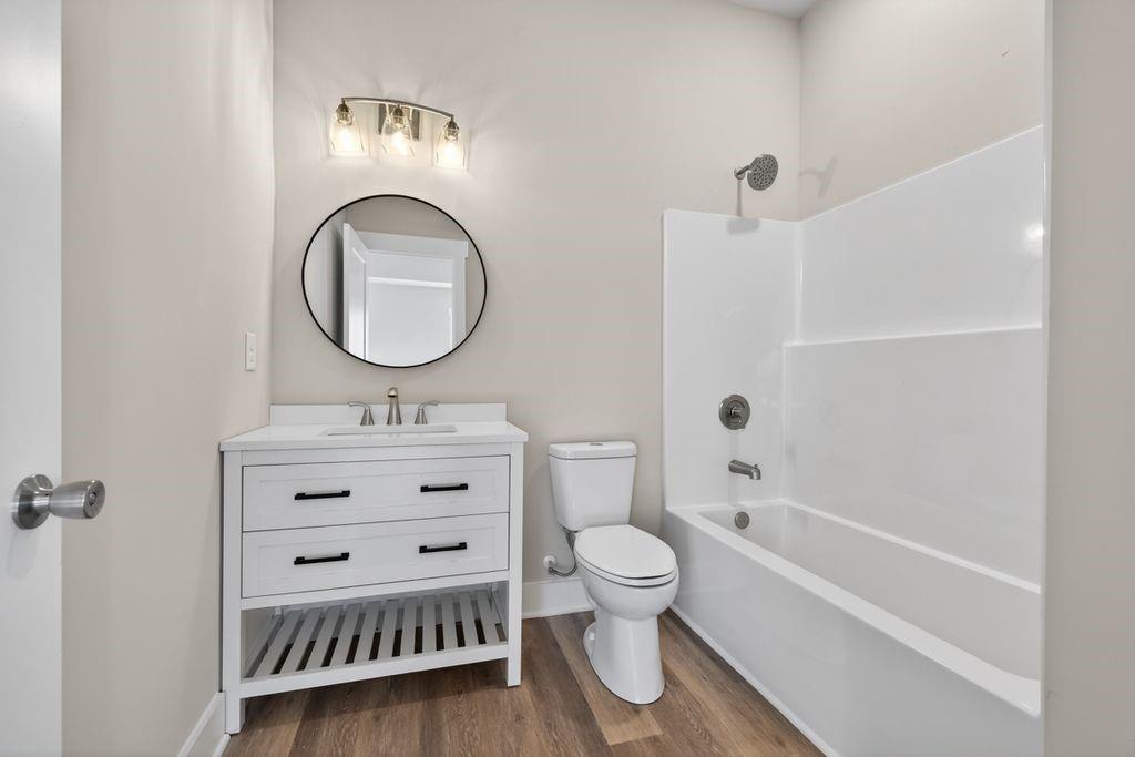 4947 Old Orr Road Flowery Branch, GA 30542 - Photo 55 of 60 a bathroom with a toilet a sink a mirror and shower