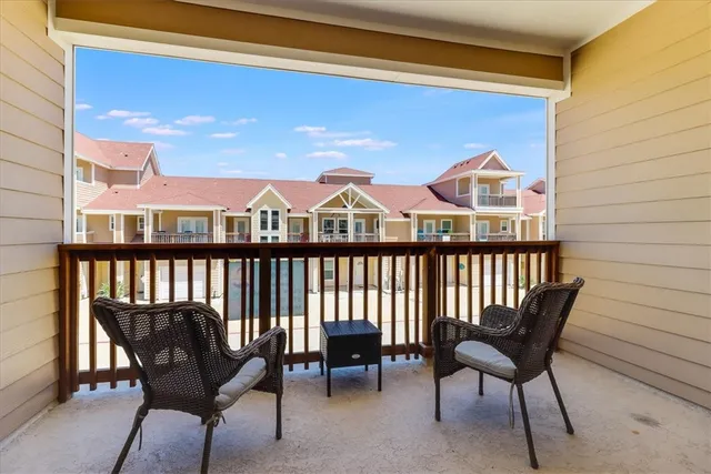 a view of a chairs and table in the balcony