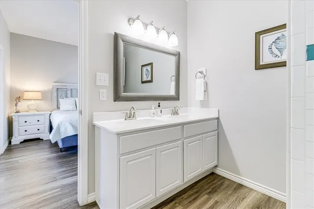 a spacious bathroom with a double vanity sink and a mirror