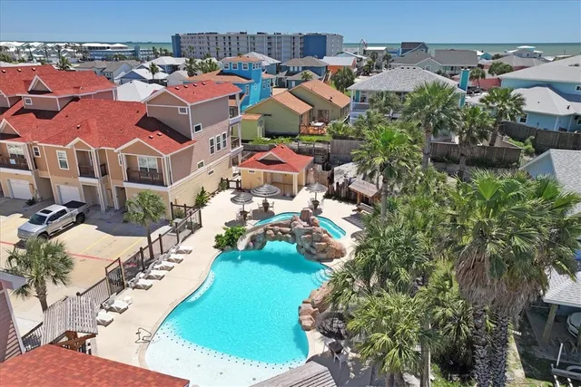an aerial view of multiple houses with yard