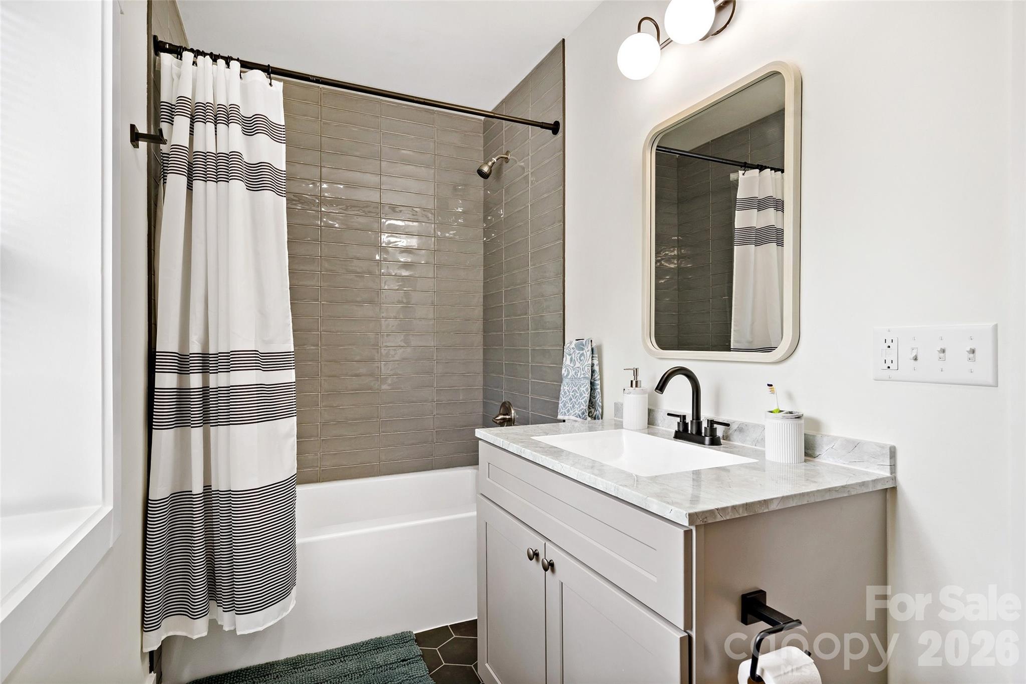 153 Arrowood Corner Road Mars Hill, NC 28754 - Photo 11 of 34 a bathroom with a tub sink and mirror