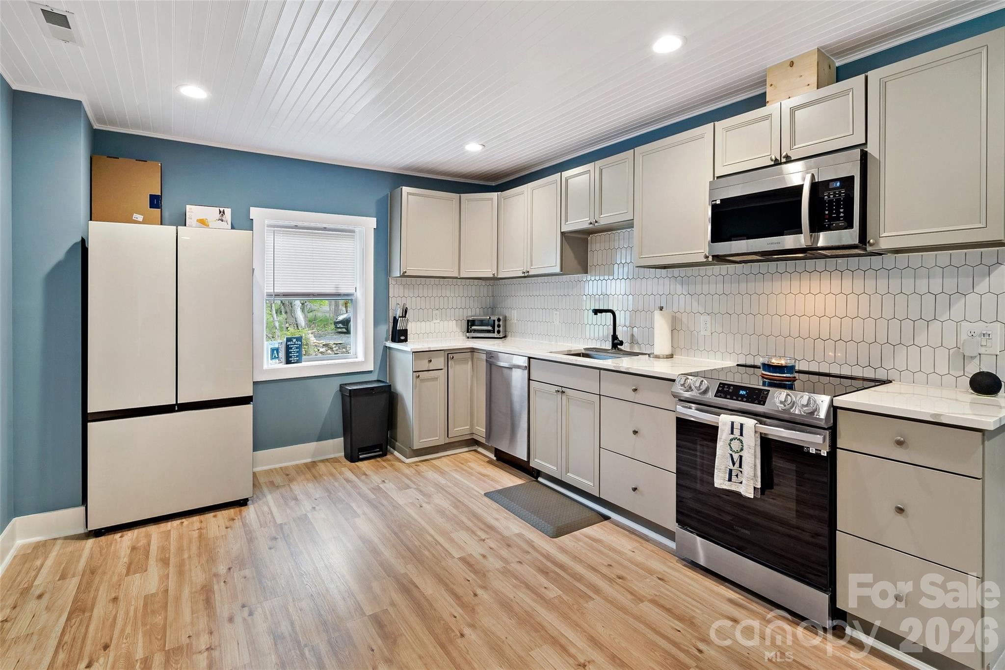 153 Arrowood Corner Road Mars Hill, NC 28754 - Photo 14 of 34 a kitchen with stainless steel appliances a refrigerator stove microwave sink and cabinets