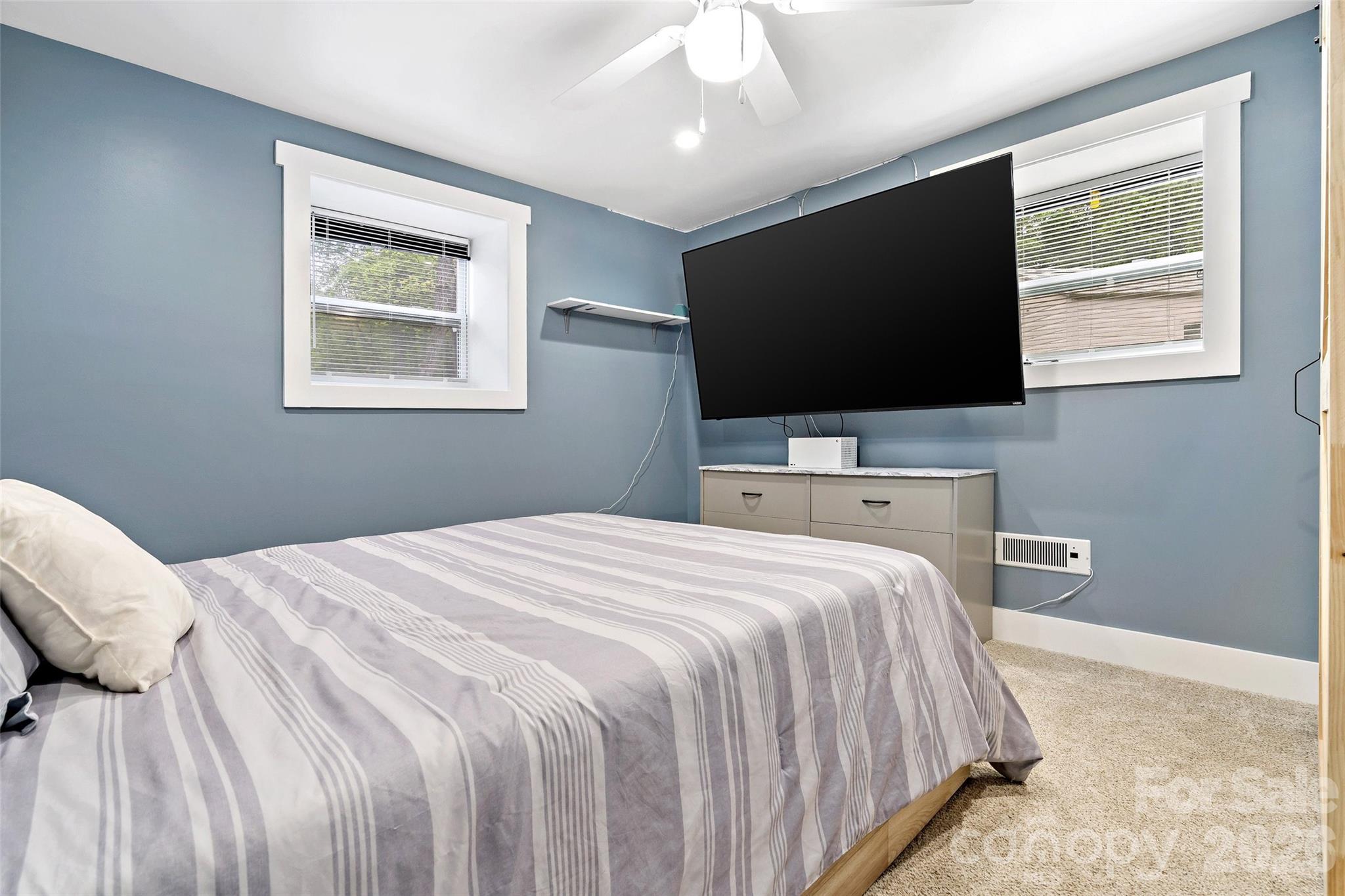 153 Arrowood Corner Road Mars Hill, NC 28754 - Photo 24 of 34 a bedroom with a bed and a flat screen tv