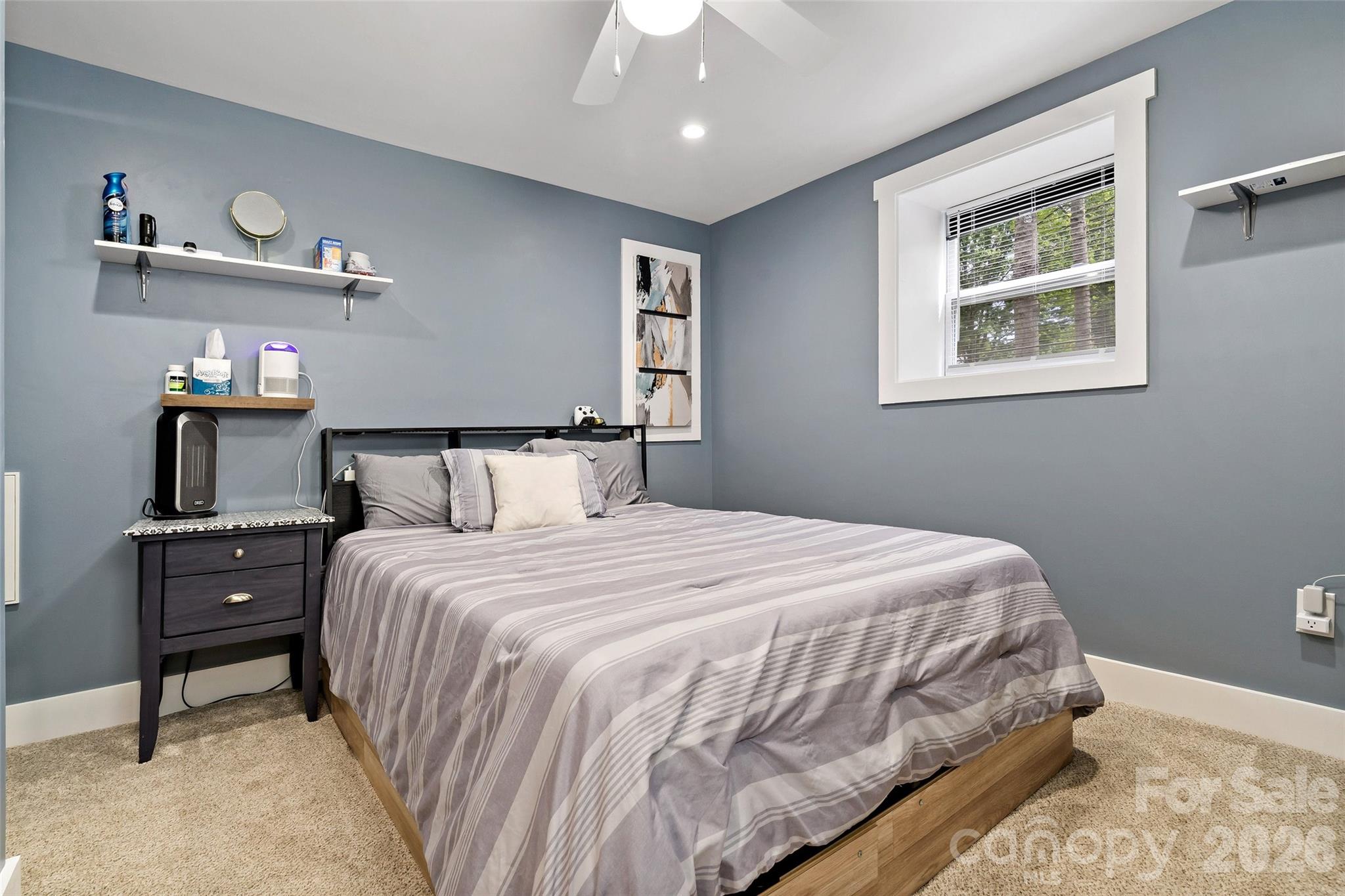 153 Arrowood Corner Road Mars Hill, NC 28754 - Photo 25 of 34 a bedroom with a bed and wooden floor