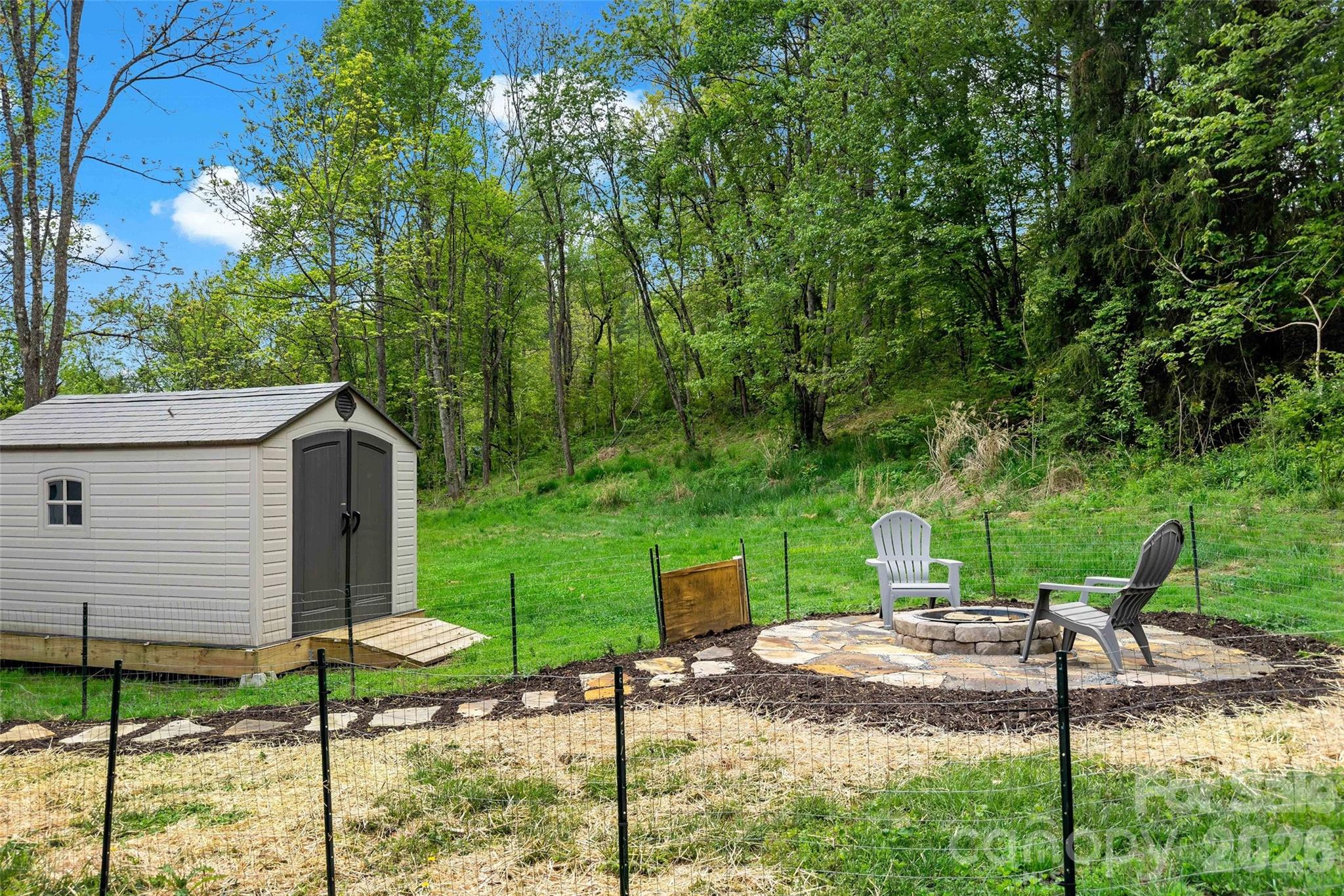 153 Arrowood Corner Road Mars Hill, NC 28754 - Photo 29 of 34 a view of a house with backyard and a tree