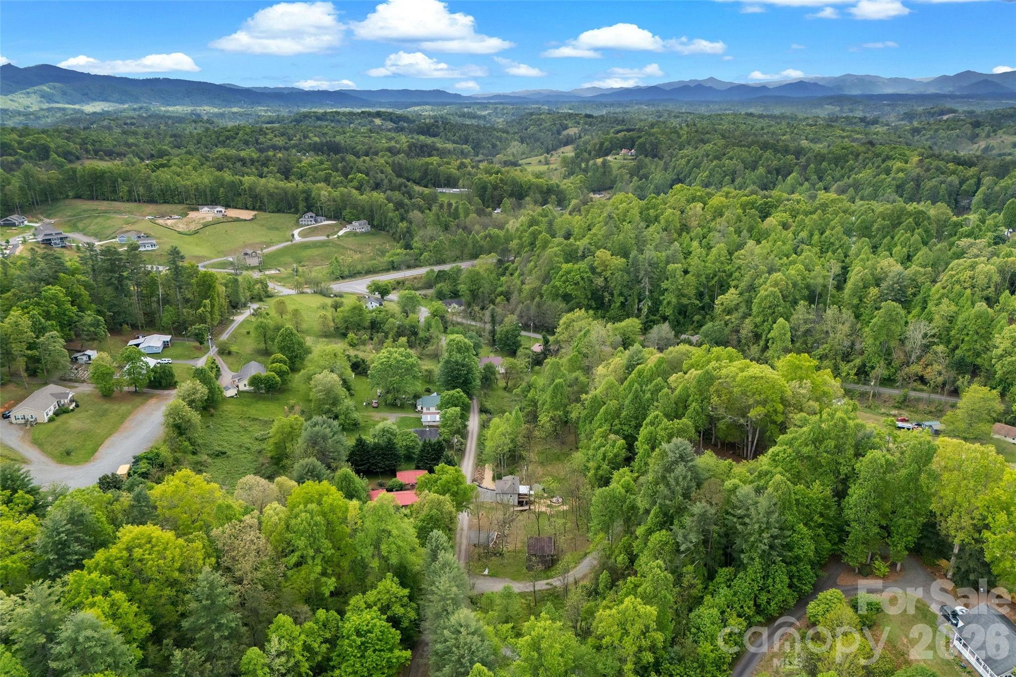 153 Arrowood Corner Road Mars Hill, NC 28754 - Photo 34 of 34 a view of a city with lush green forest