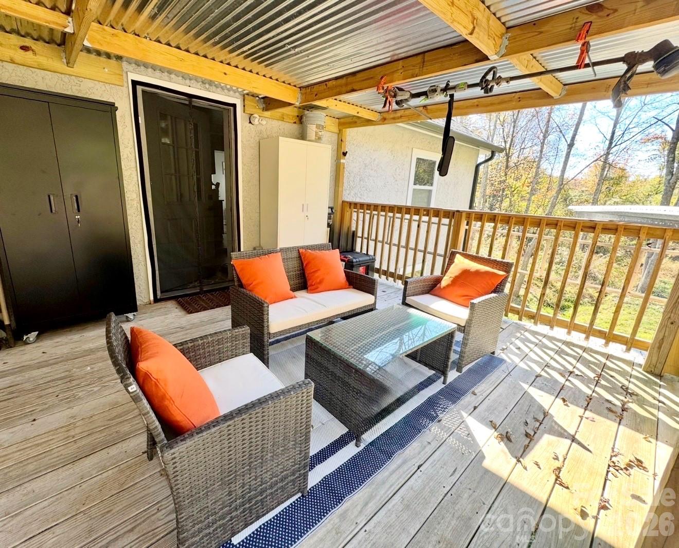 153 Arrowood Corner Road Mars Hill, NC 28754 - Photo 5 of 34 a outdoor space with the couches and dining table with wooden floor
