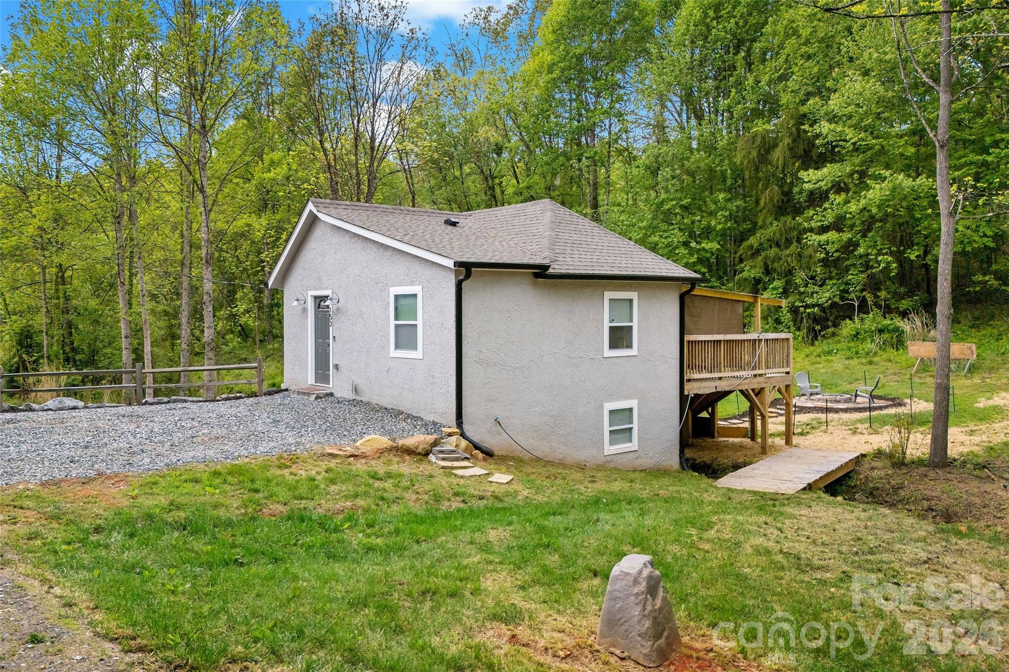 153 Arrowood Corner Road Mars Hill, NC 28754 - Photo 8 of 34 a house view with a garden space