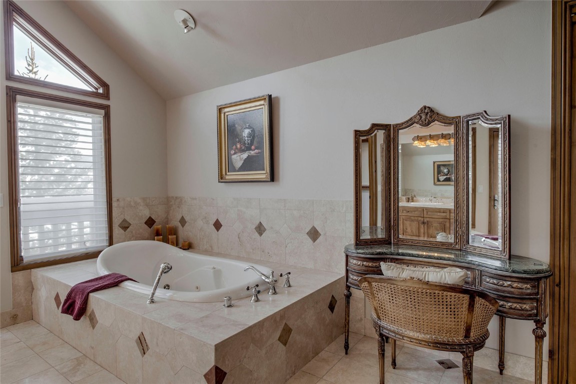 68 Snowy Ridge Road Breckenridge, CO 80424 - Photo 34 of 42 a bathroom with a tub sink and mirror