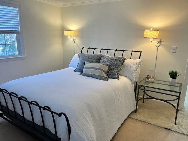 a bedroom with a bed and a television