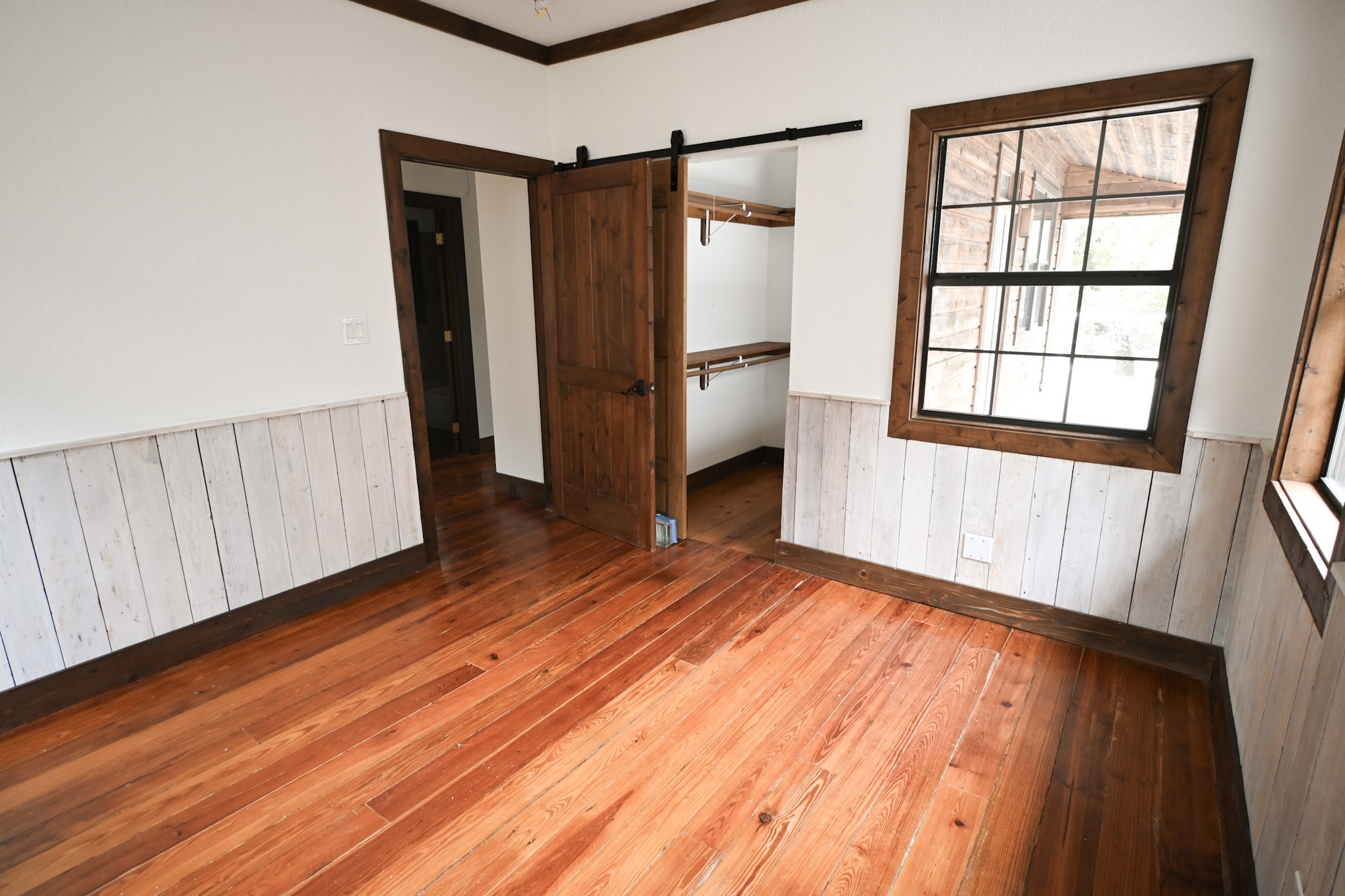 15104 Texas Street Austin, TX 78734 - Photo 13 of 18 a view of an empty room with wooden floor and a window