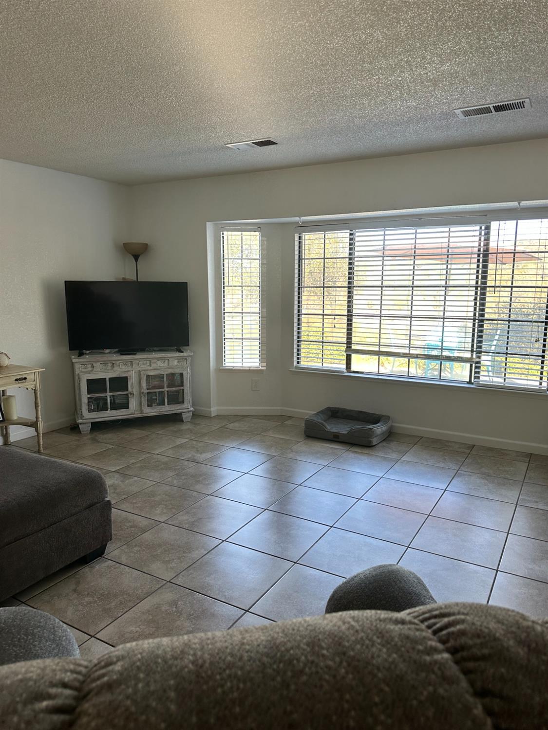 46725 Picayune Creek Road Coarsegold, CA 93614 - Photo 9 of 49 a living room with a large window and a flat screen tv