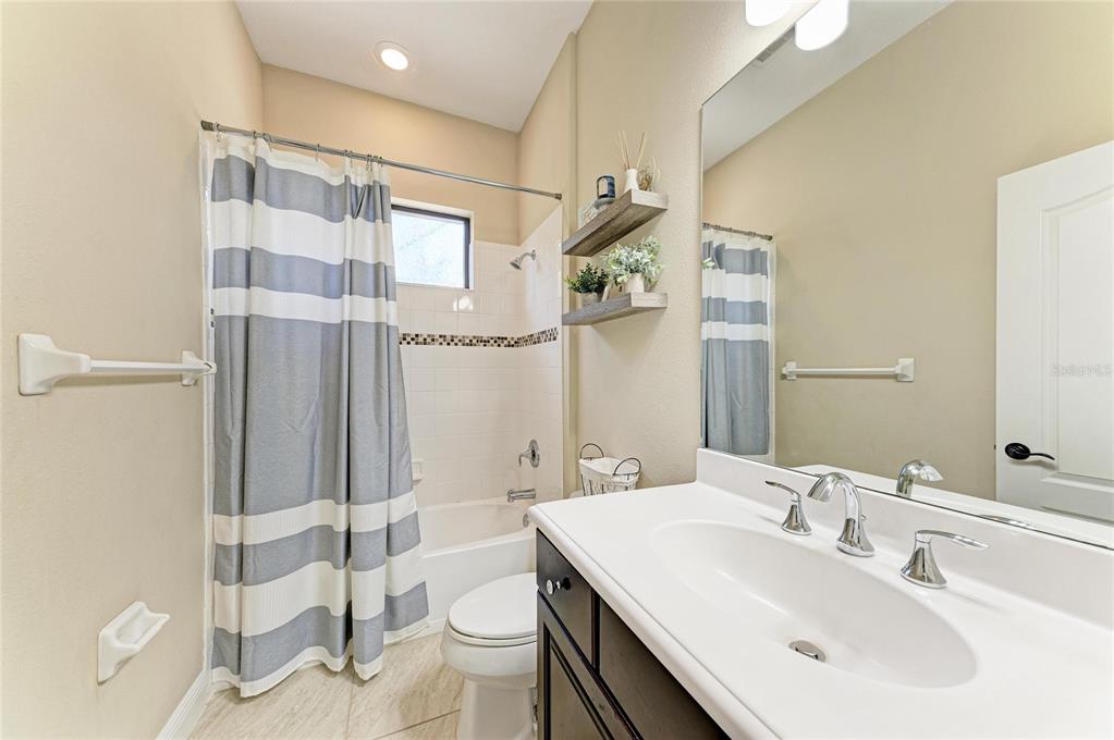 12642 Harney Street Venice, FL 34293 - Photo 40 of 85 a bathroom with a sink toilet and shower