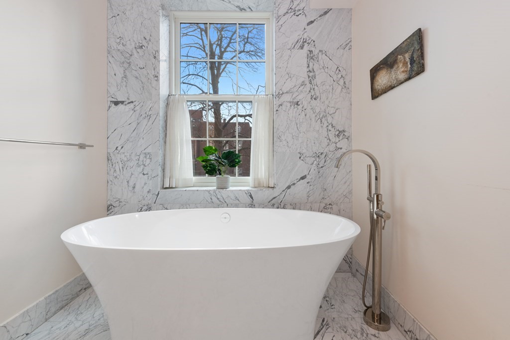 28 Mt Vernon Street, Unit 2 Boston, MA 02108 - Photo 14 of 31 a white bath tub sitting in a bathroom next to a window