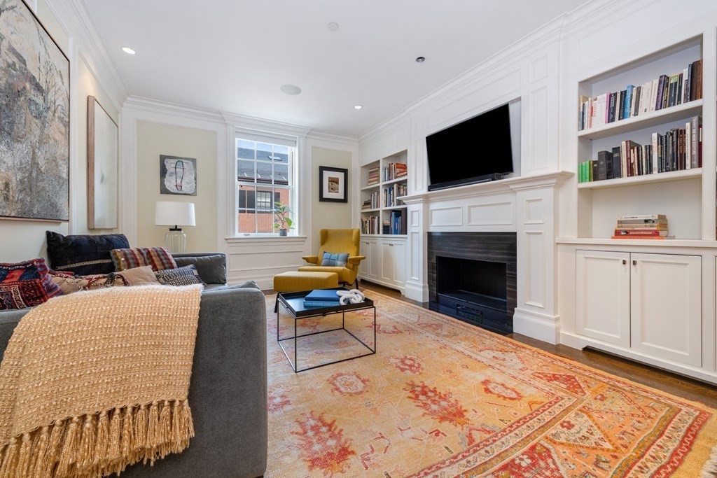 28 Mt Vernon Street, Unit 2 Boston, MA 02108 - Photo 17 of 31 a living room with furniture a flat screen tv and a fireplace
