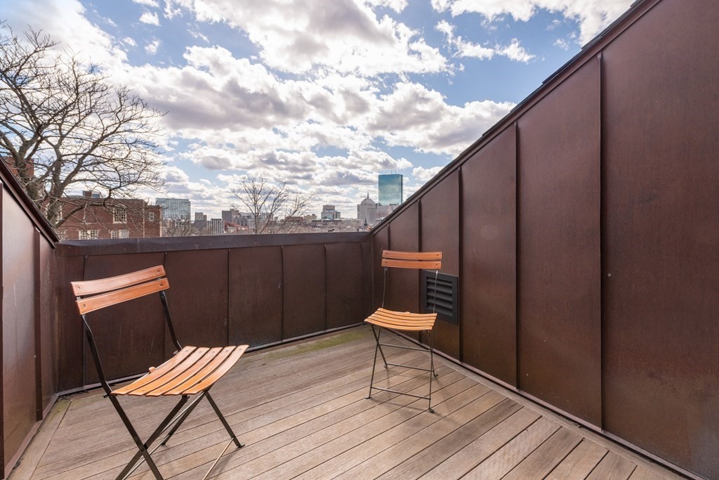 28 Mt Vernon Street, Unit 2 Boston, MA 02108 - Photo 30 of 31 a balcony with wooden chairs and bench