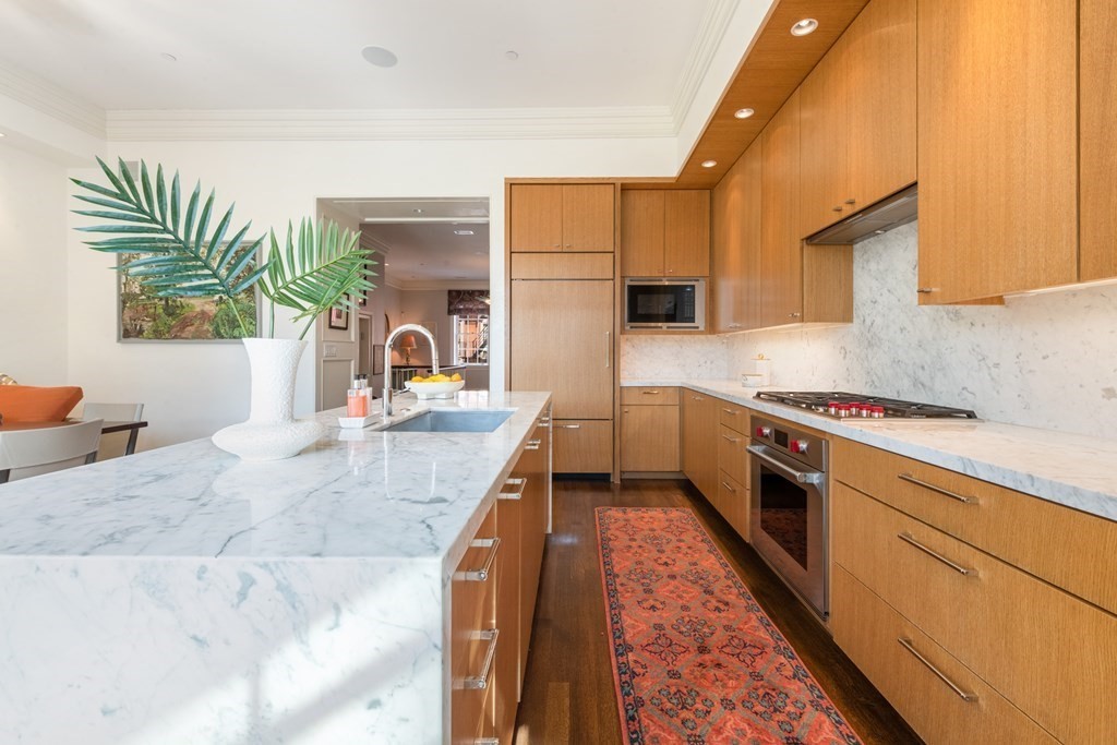 28 Mt Vernon Street, Unit 2 Boston, MA 02108 - Photo 7 of 31 a kitchen with a stove a sink and a refrigerator