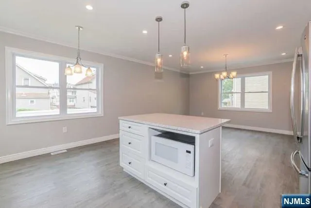 a kitchen that has a lot of windows in it