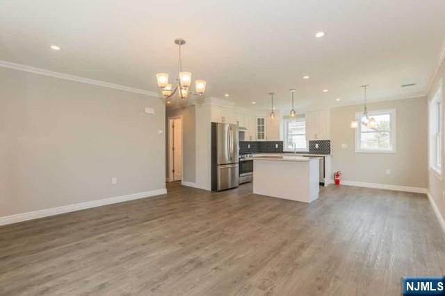 24 Henry Place, Unit 2 Hackensack, NJ 07601 - Photo 14 of 26 a view of a kitchen with a sink wooden cabinets and stainless steel appliances