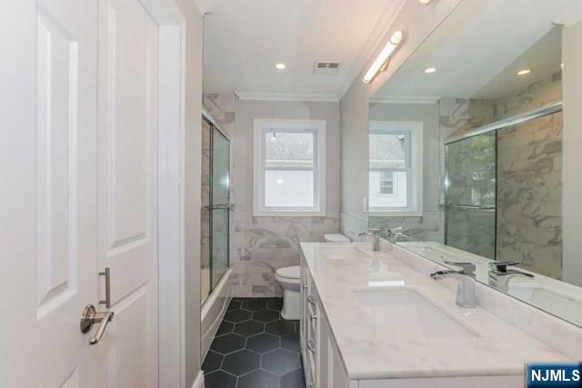 24 Henry Place, Unit 2 Hackensack, NJ 07601 - Photo 16 of 26 a spacious bathroom with a double vanity sink a mirror and a shower