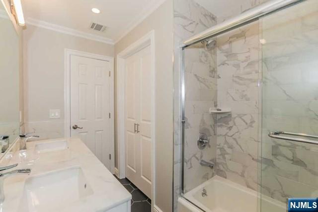 24 Henry Place, Unit 2 Hackensack, NJ 07601 - Photo 17 of 26 a bathroom with a bathtub and a shower