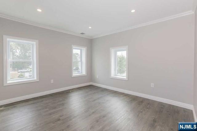 24 Henry Place, Unit 2 Hackensack, NJ 07601 - Photo 18 of 26 a view of an empty room with wooden floor and window