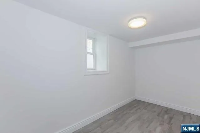 a view of a small space with wooden floor and a window
