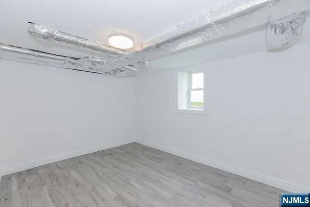 a view of a room with wooden floor and window