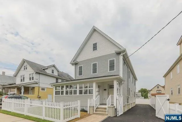a view of a white house with large windows