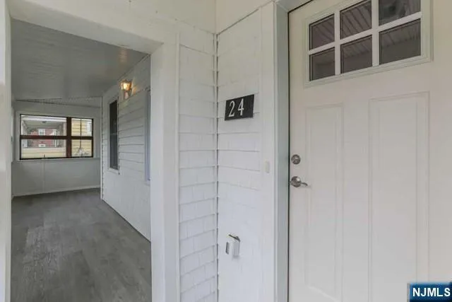 a view of a hallway with windows and entryway