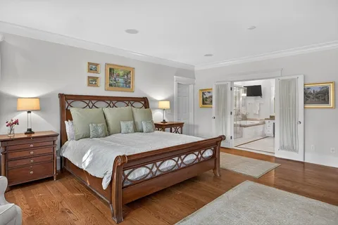 a bedroom with a bed and a lamp on table