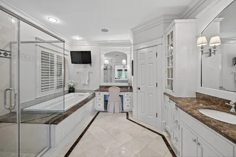 a spacious bathroom with a granite countertop tub sink and mirror