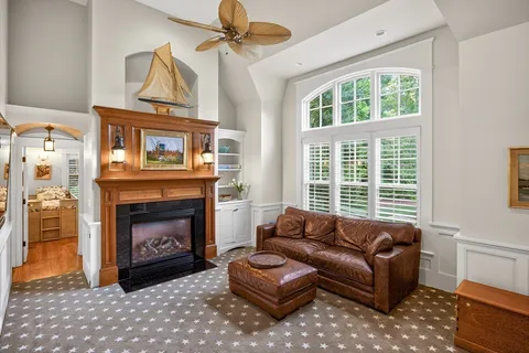 a living room with furniture a window and a fireplace
