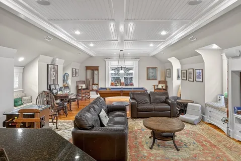 a living room with furniture and a chandelier