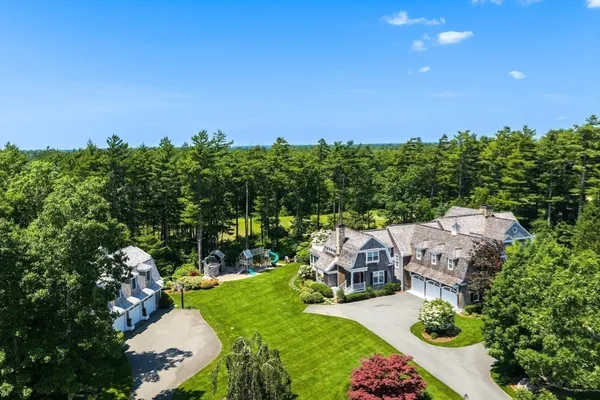 an aerial view of a house with yard swimming pool and outdoor seating