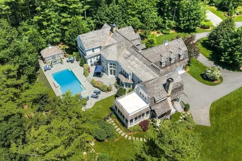 an aerial view of a house with garden space and street view