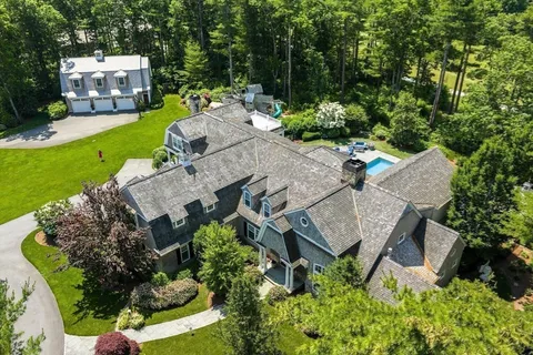 an aerial view of a house with garden space and street view
