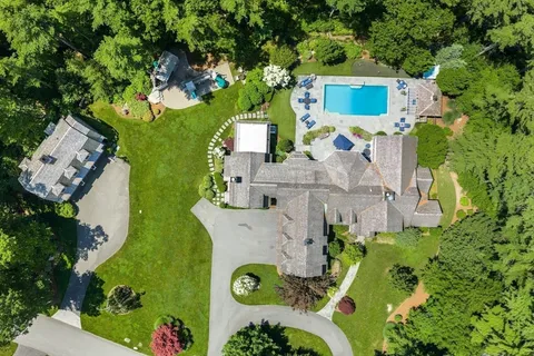 an aerial view of residential house with outdoor space and parking