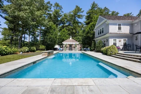 a swimming pool view with a outdoor seating