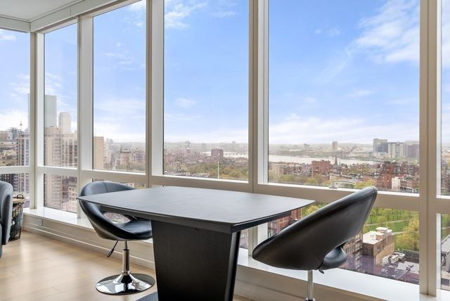 a view of a balcony with furniture and floor to ceiling window