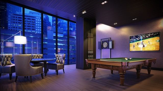 a room with furniture pool table table and a projector