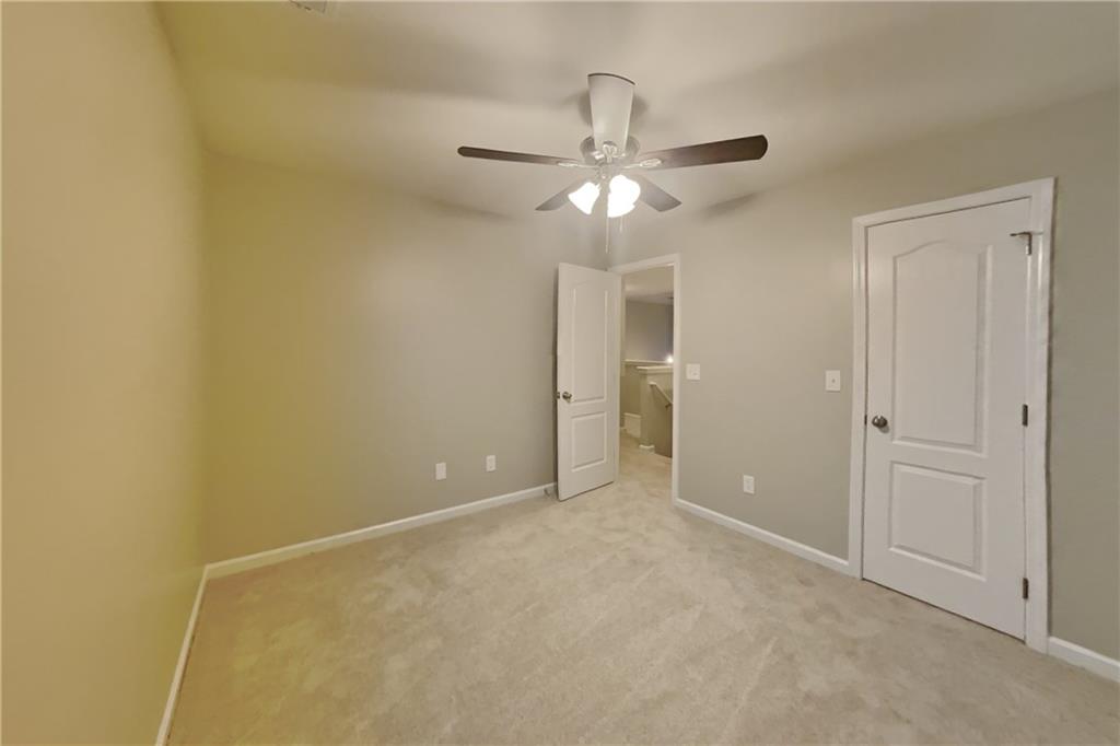 15 Jessica Lane Dallas, GA 30157 - Photo 14 of 23 an empty room with a ceiling fan and a window