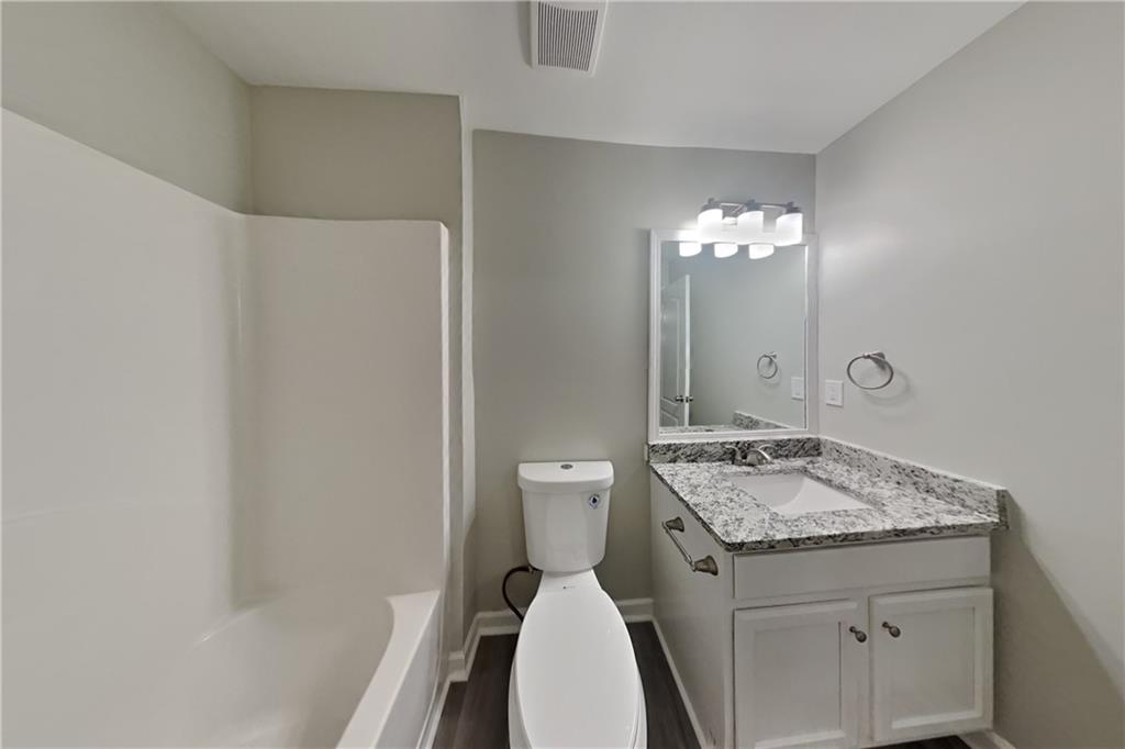 15 Jessica Lane Dallas, GA 30157 - Photo 17 of 23 a bathroom with a granite countertop sink a toilet a mirror and shower