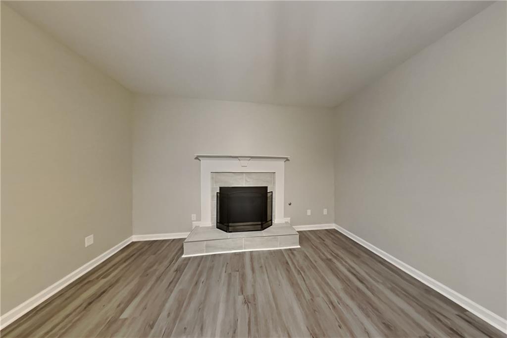 15 Jessica Lane Dallas, GA 30157 - Photo 2 of 23 a view of an empty room with wooden floor and a window