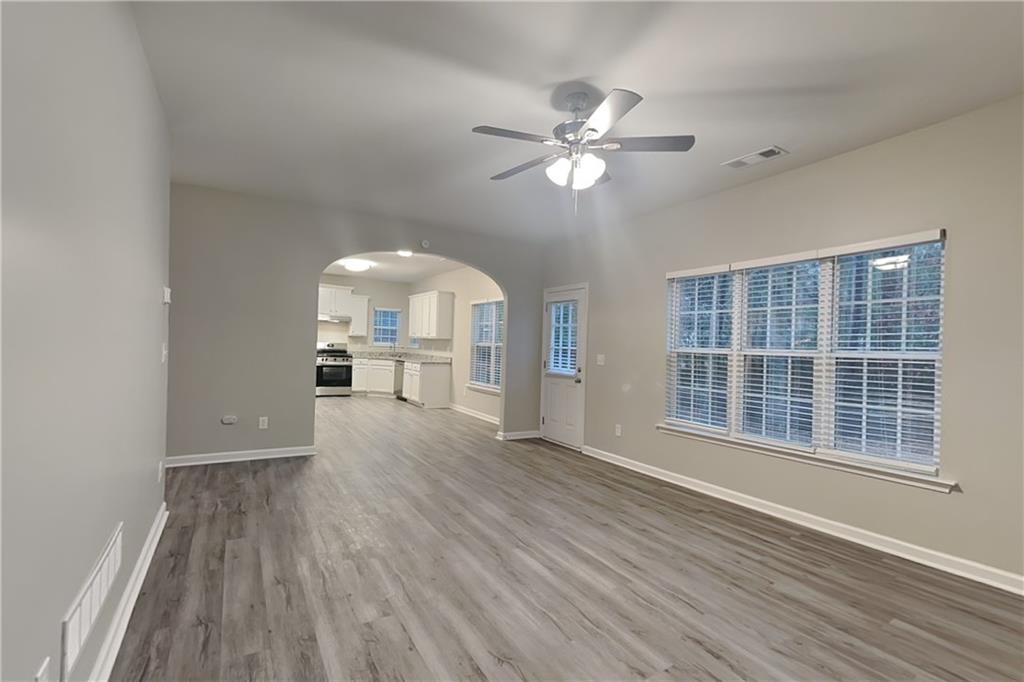15 Jessica Lane Dallas, GA 30157 - Photo 3 of 23 a view of a livingroom with wooden floor and a ceiling fan