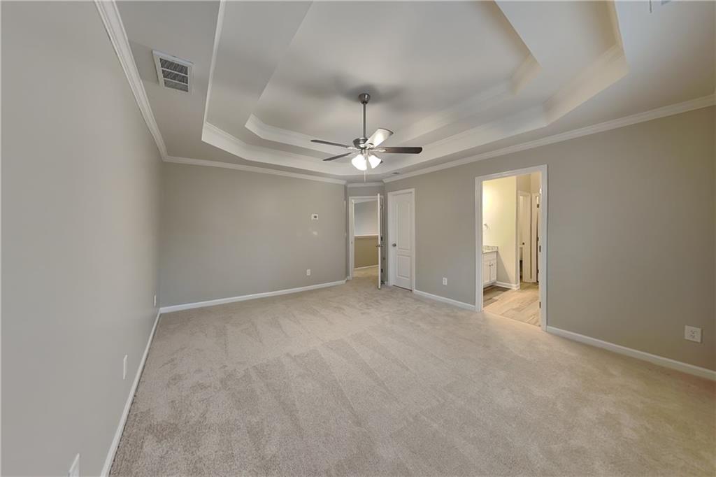 15 Jessica Lane Dallas, GA 30157 - Photo 7 of 23 an empty room with a chandelier fan and wooden floor