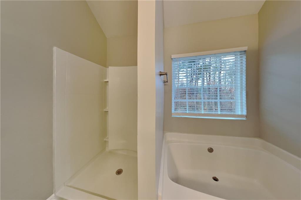 15 Jessica Lane Dallas, GA 30157 - Photo 10 of 23 a white bath tub sitting next to a shower