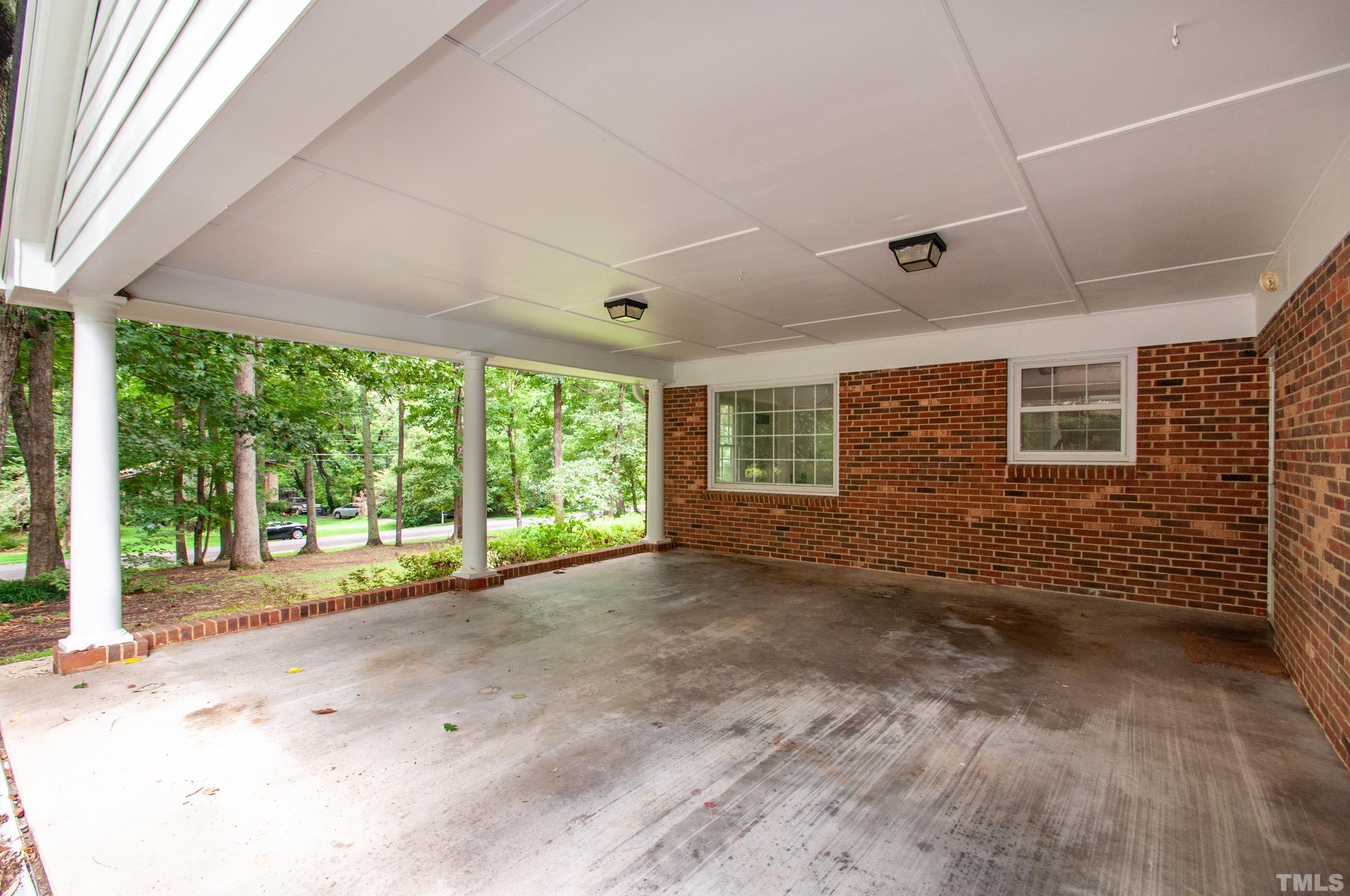 8408 Azalea Place Raleigh, NC 27613 - Photo 3 of 48 a view of a porch with wooden floor and floor to ceiling window